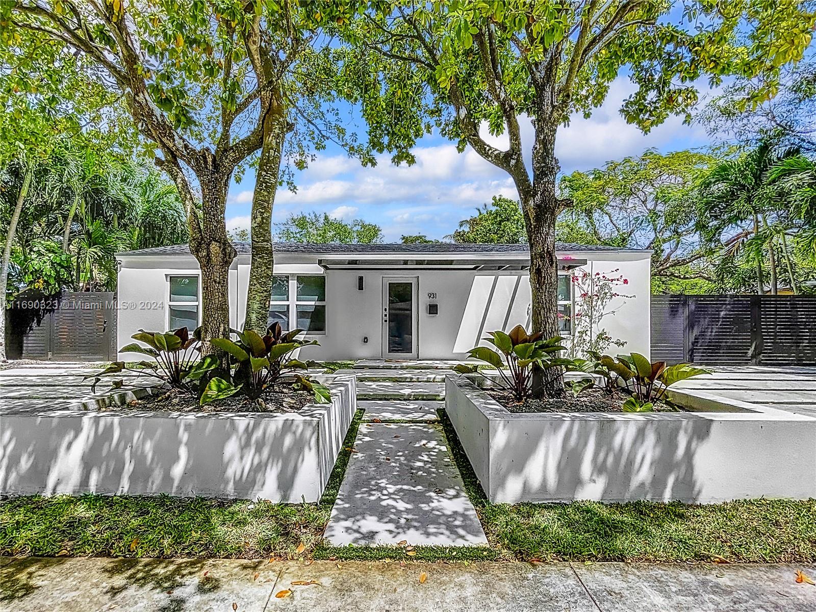 a front view of a house with a garden