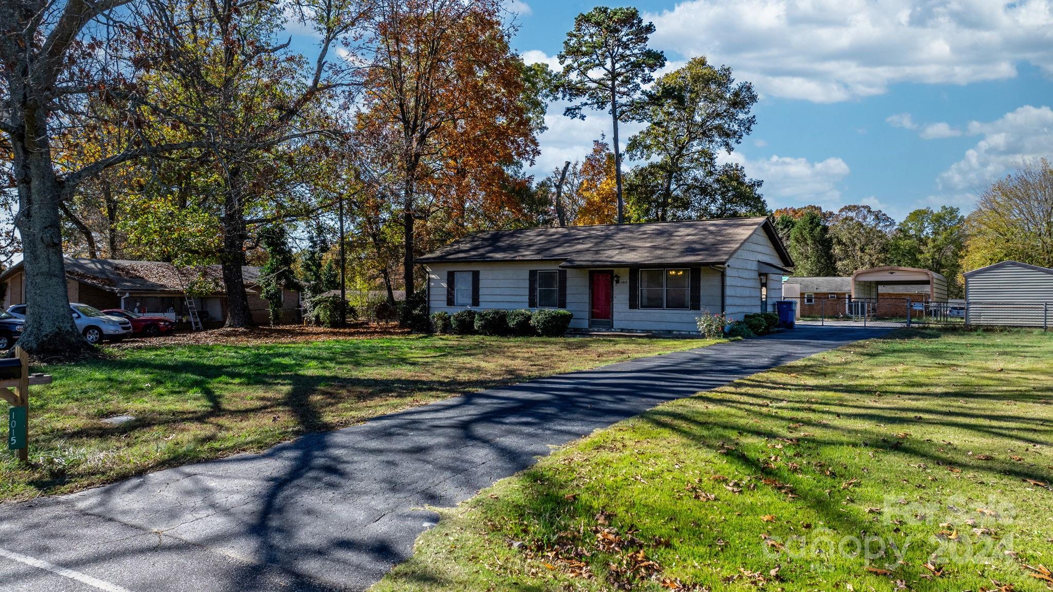 a front view of a house with a yard table and chairs