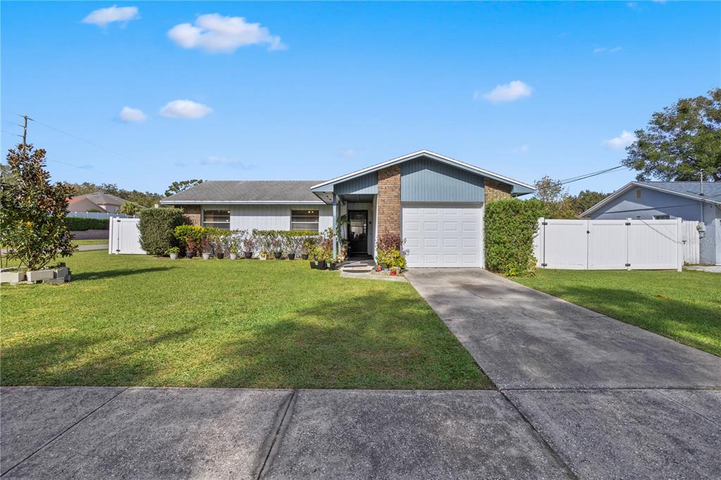 a front view of house with yard and green space