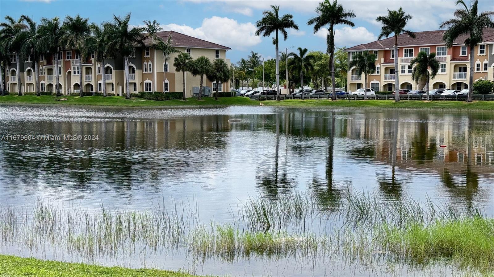 a backyard of a house with yard and lake view