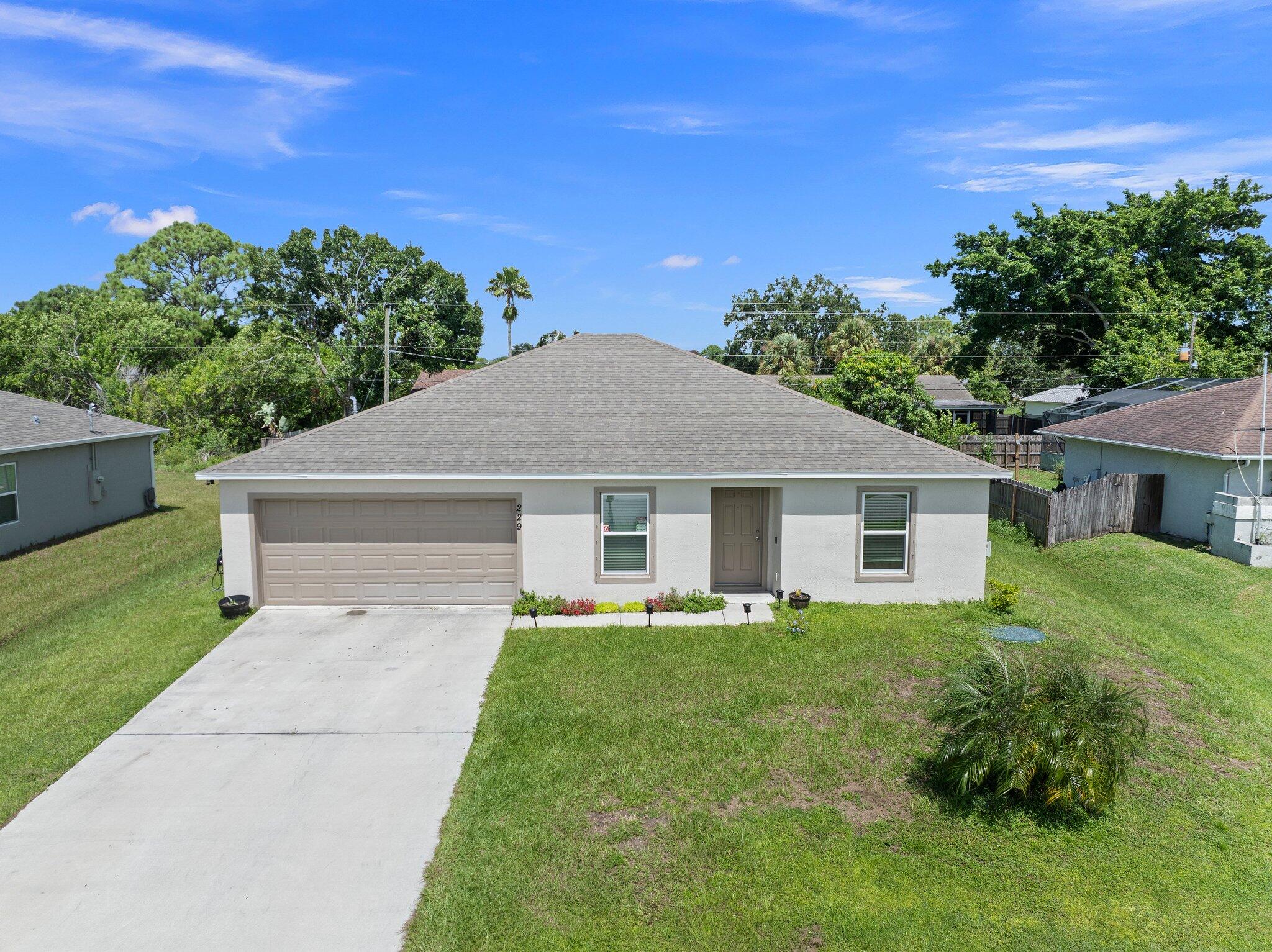 a front view of house with yard and green space