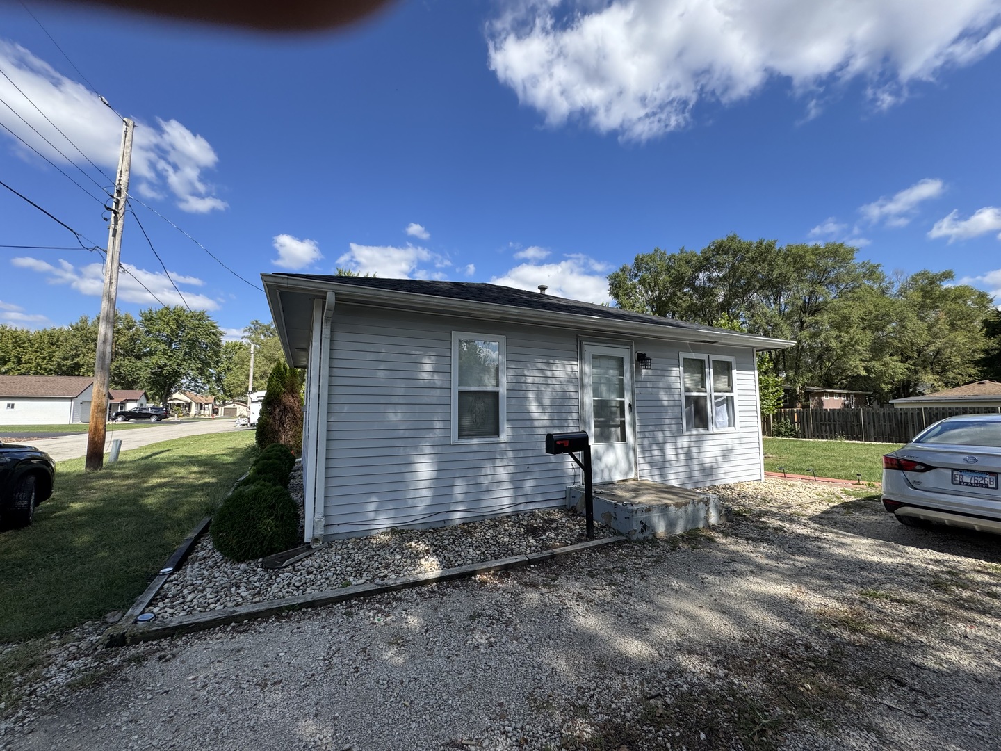 a view of house with backyard space and garden