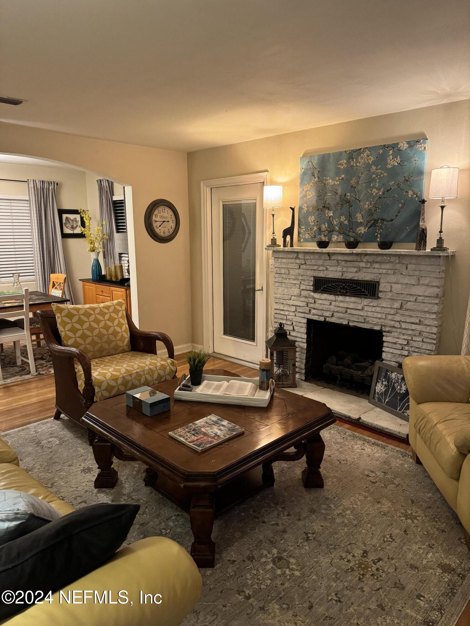 a living room with furniture and a fireplace