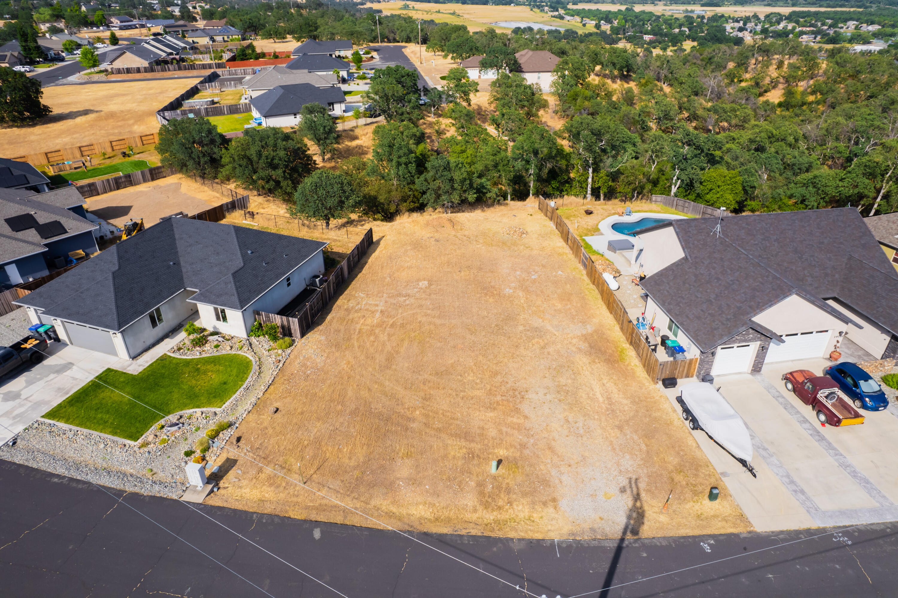 an aerial view of a house with a yard and lake view