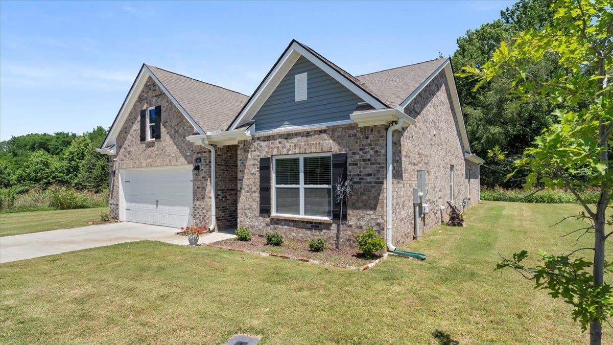 a front view of a house with garden