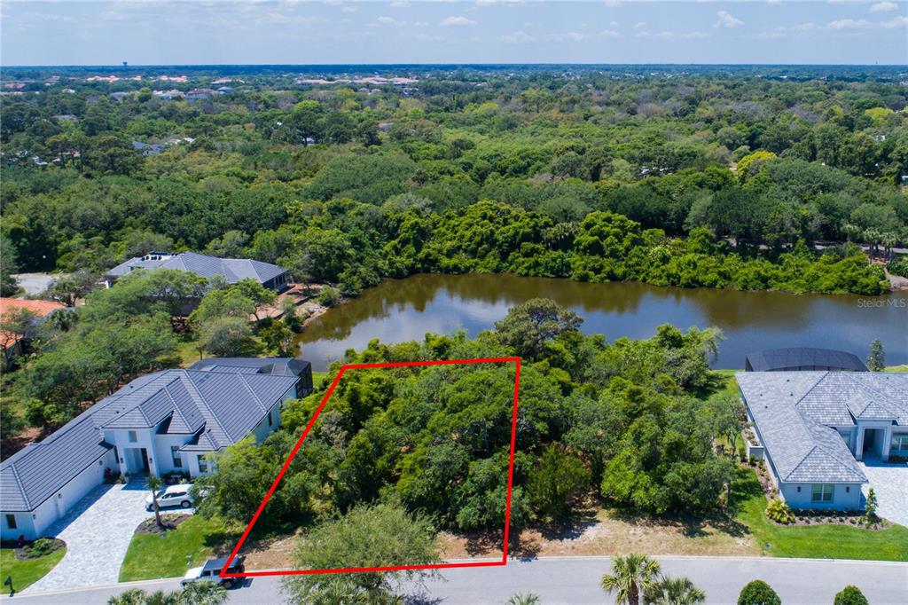 an aerial view of a houses with outdoor space and lake view