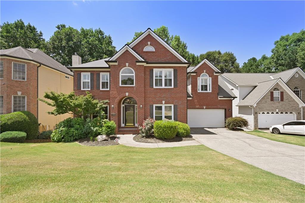 a front view of a house with a yard