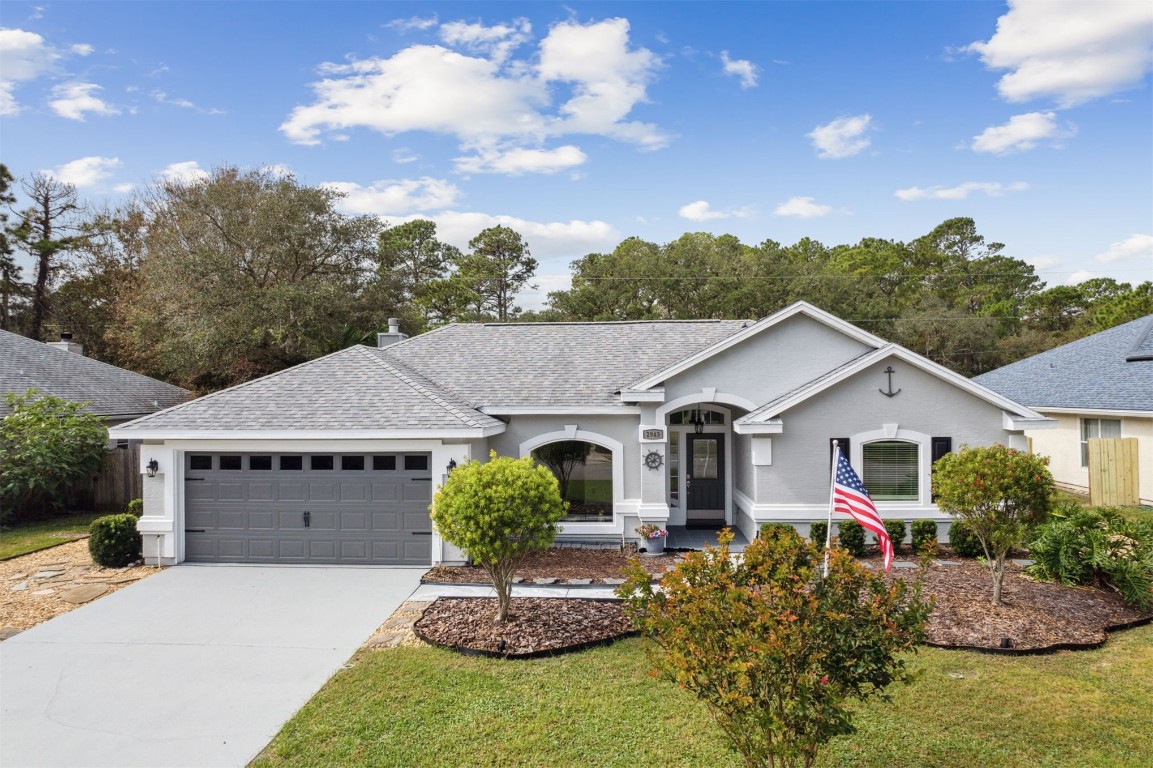 a front view of a house with a yard and garage