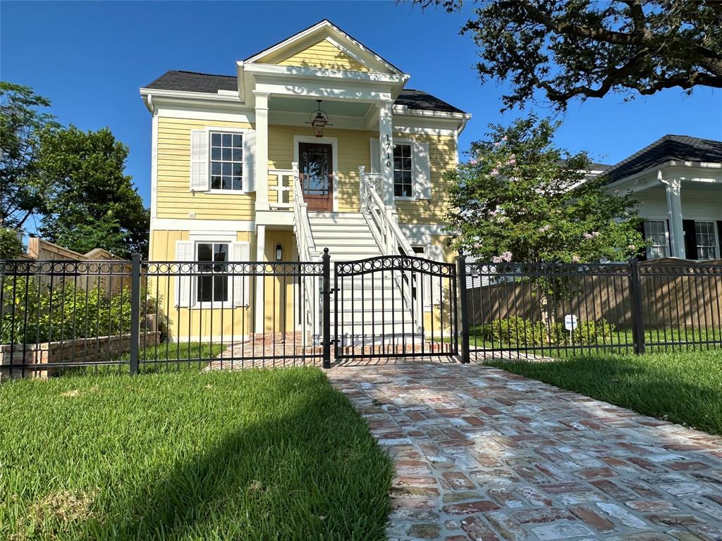 a front view of a house with a garden and plants