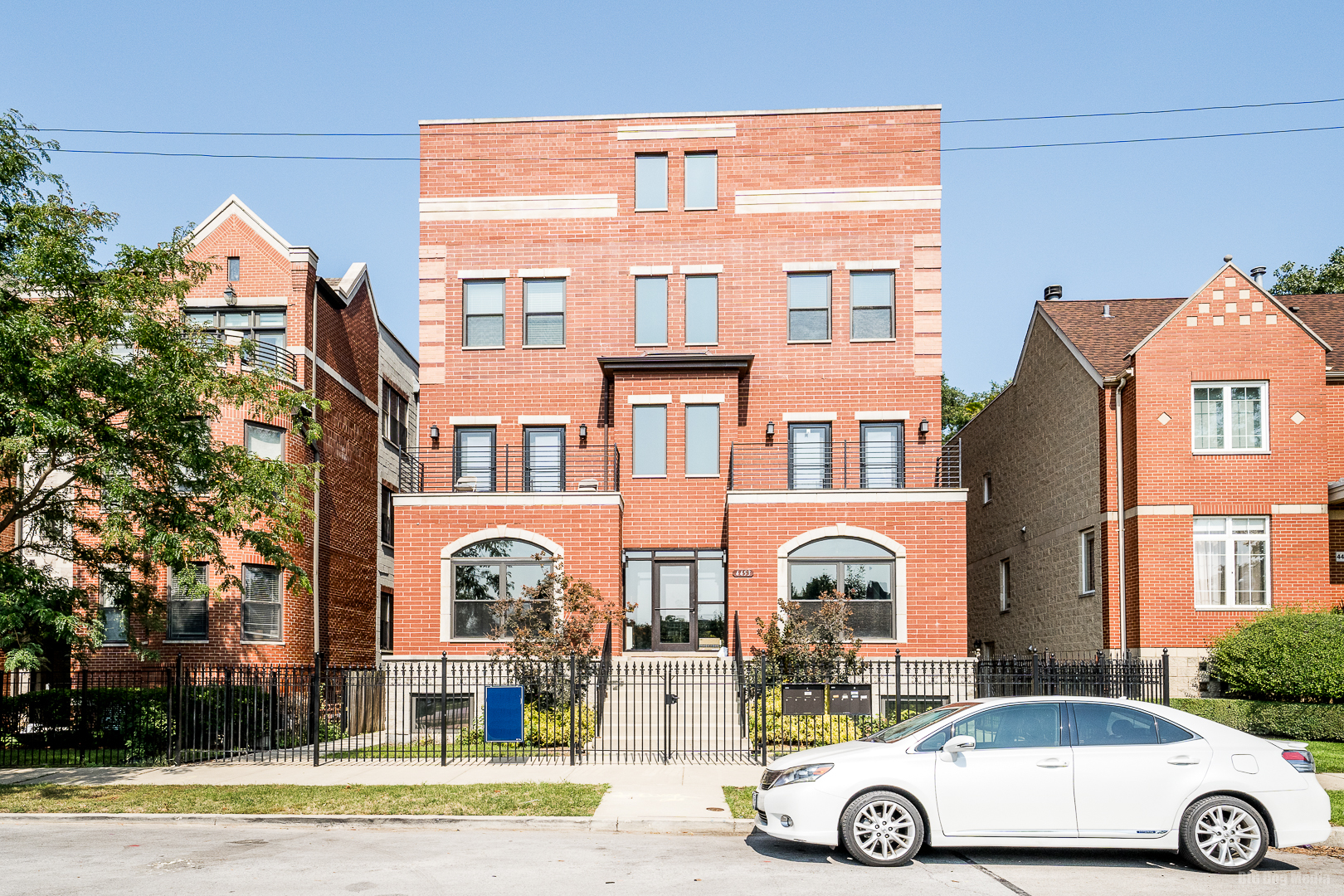 a front view of a residential apartment building with a yard