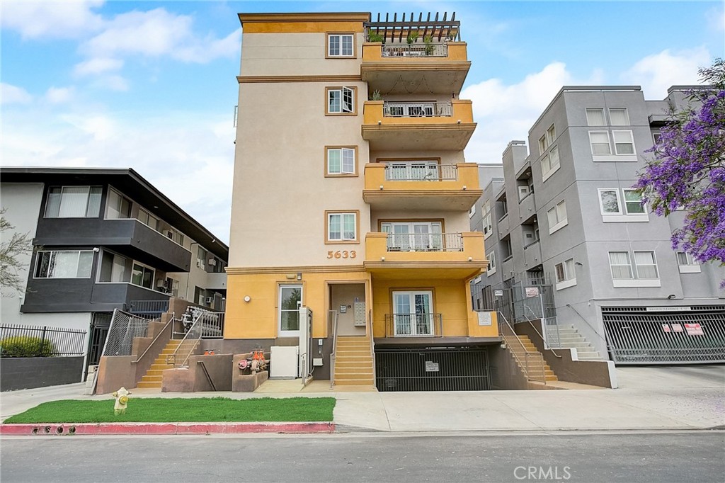 a front view of a residential apartment building with a yard