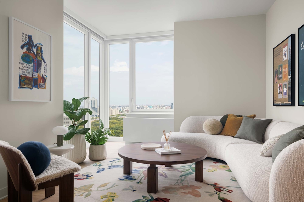 a living room with furniture and a potted plant