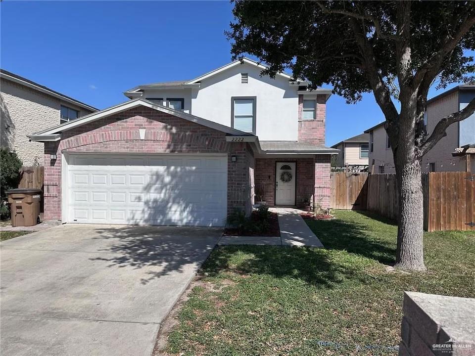 View of front property featuring a front yard and a garage