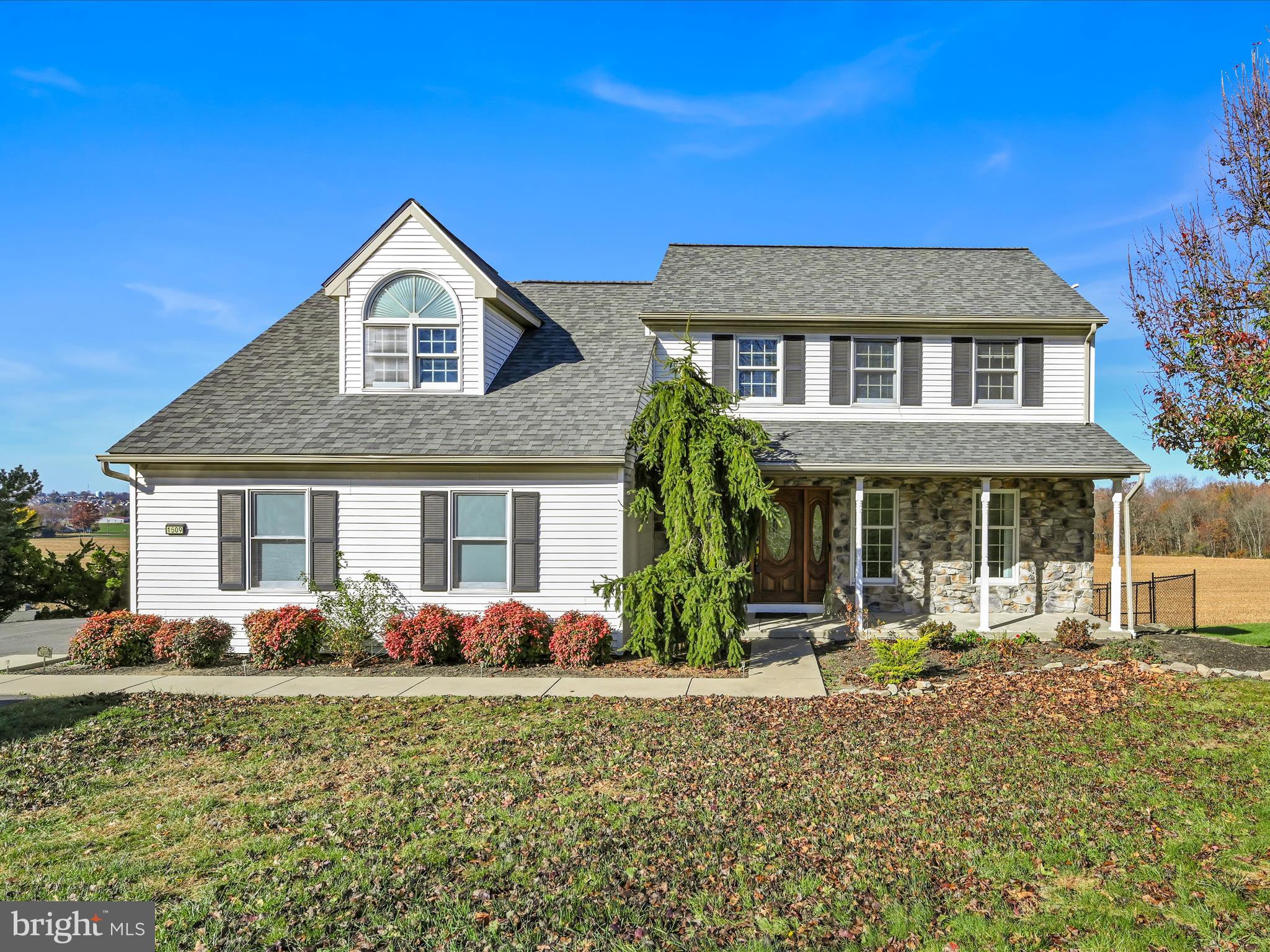 a front view of house with yard and green space