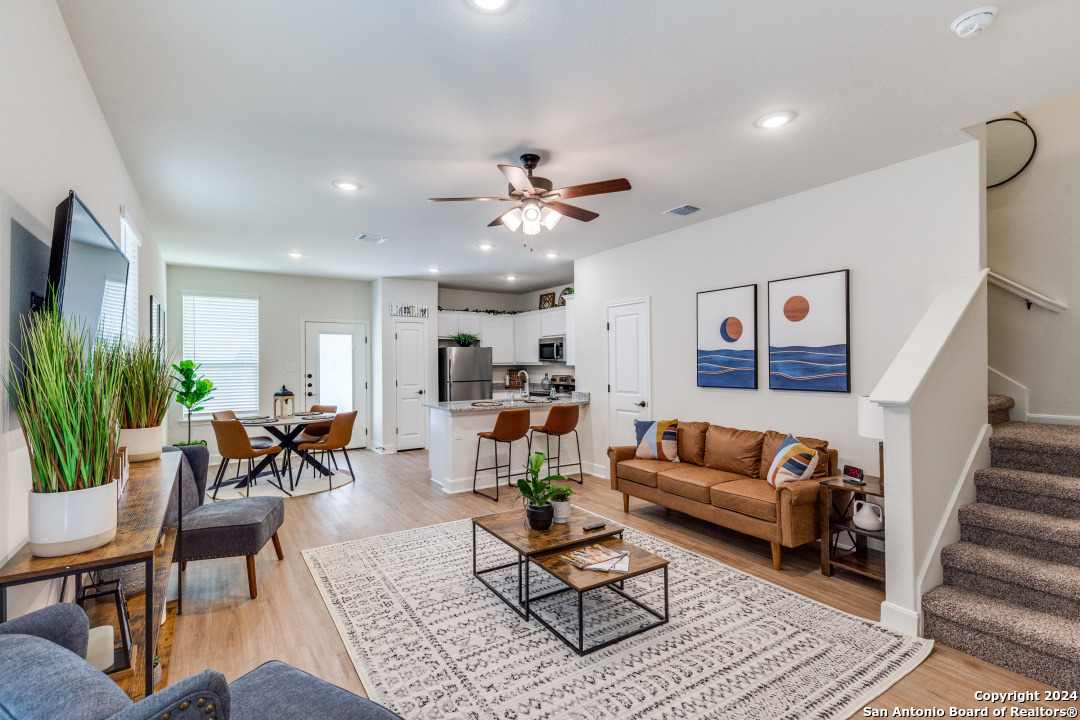 a living room with furniture or couch and a potted plant