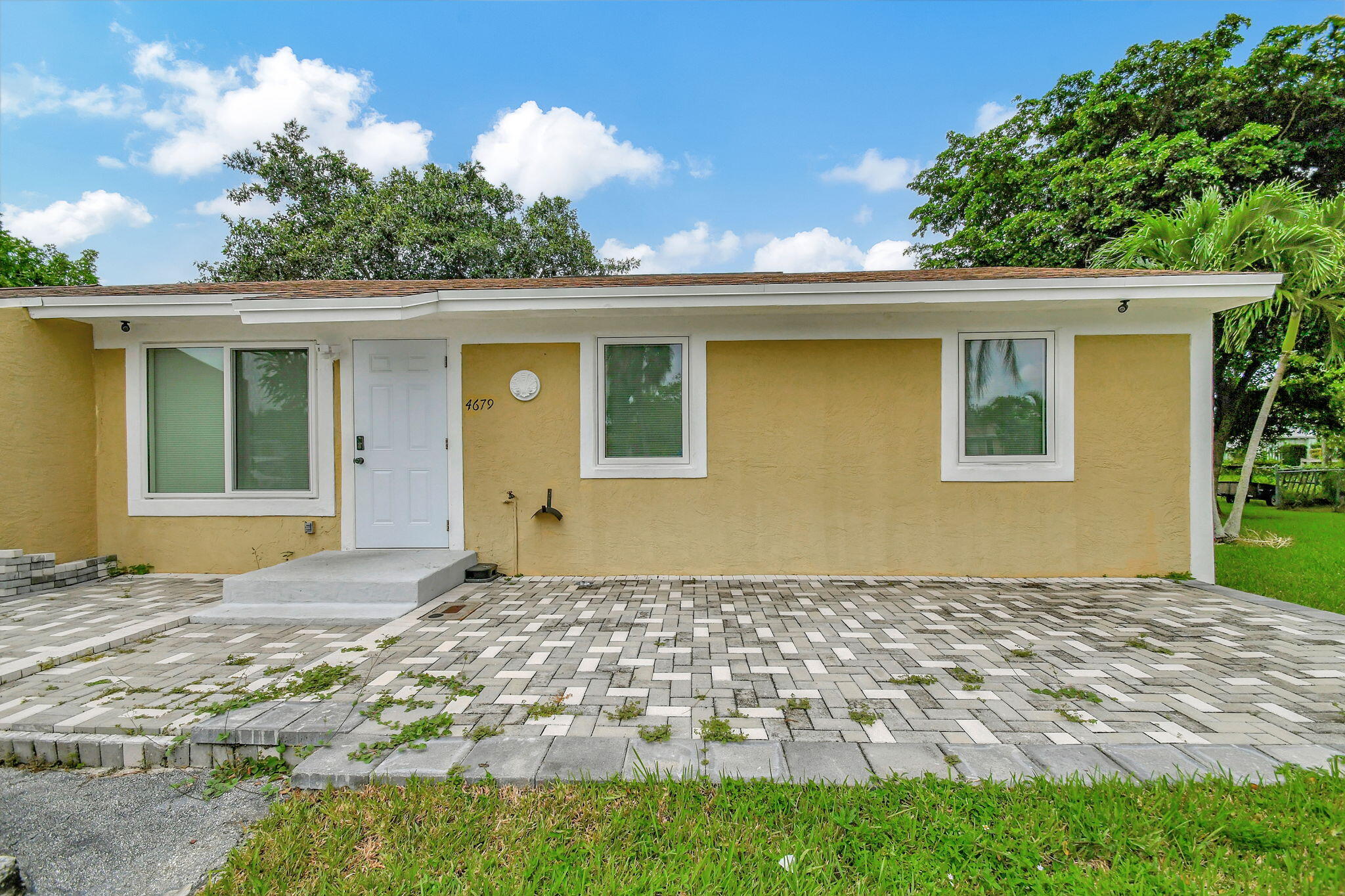 a front view of a house with a yard