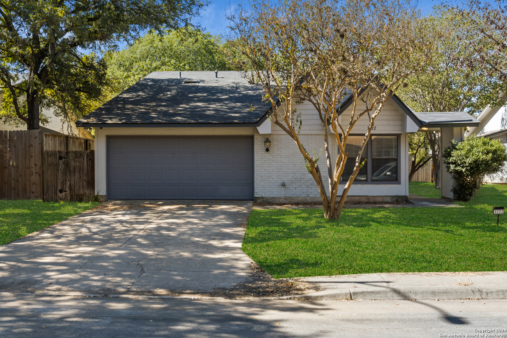 a house that has a tree in front of the house