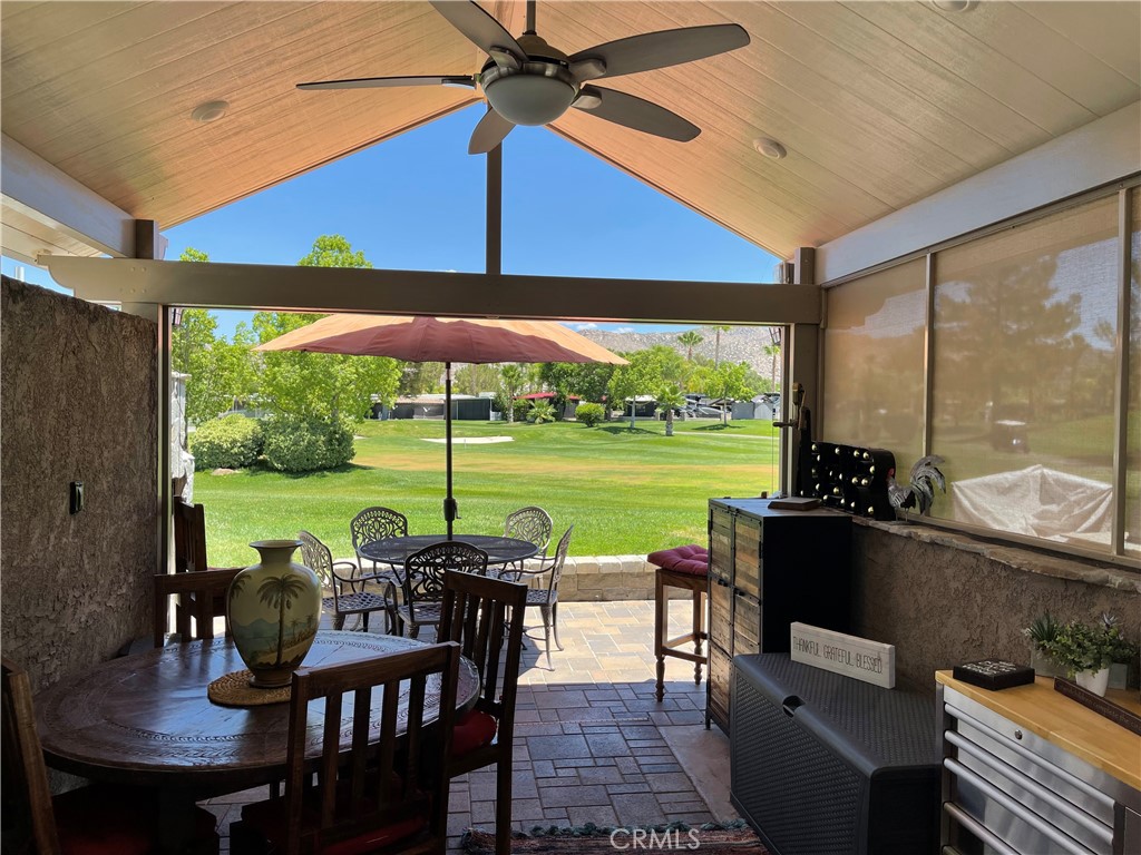 a view of a patio with a table chairs and a umbrella