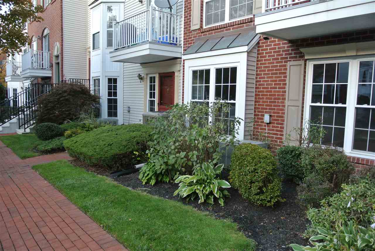 a view of a brick building next to a yard