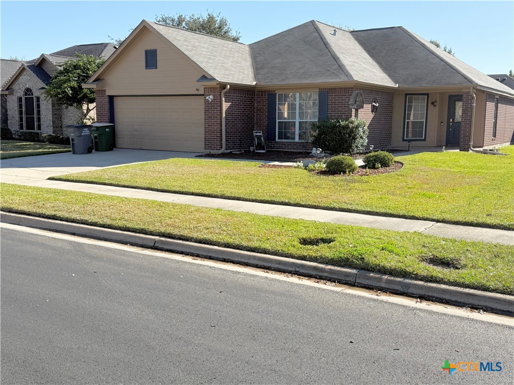 a view of a house with a patio and a yard