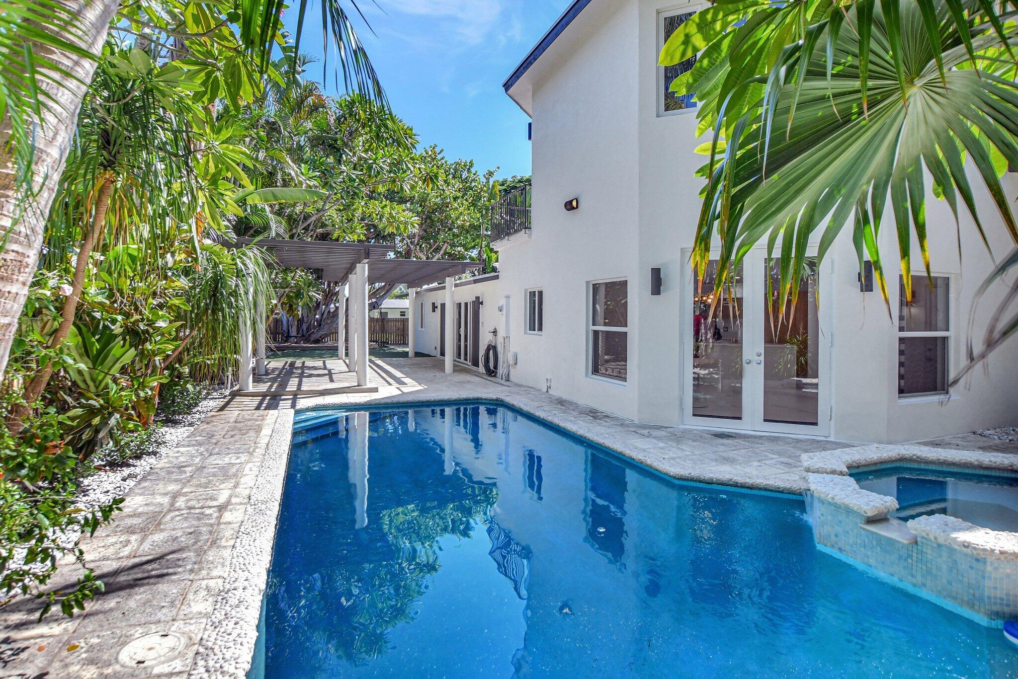 a swimming pool with outdoor seating and yard