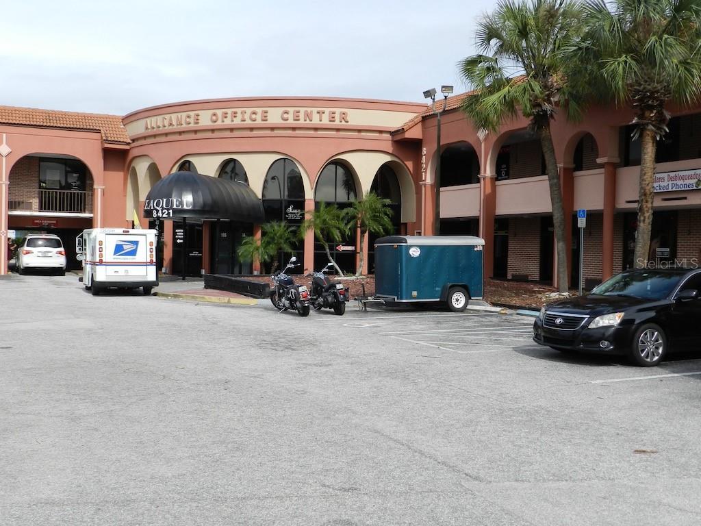 a view of a car is parked in front of a building