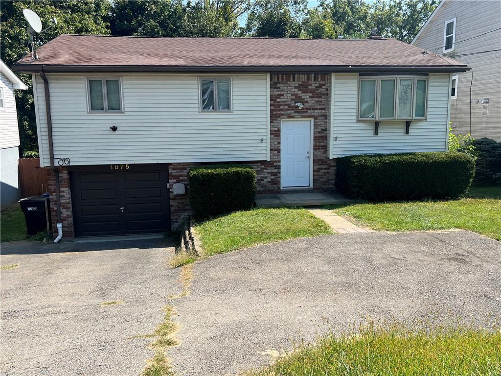 a front view of a house with yard and garage