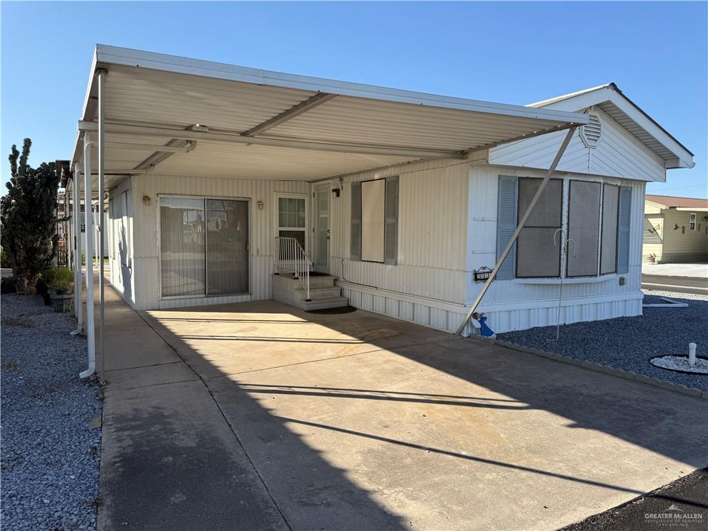 Back of house with a carport