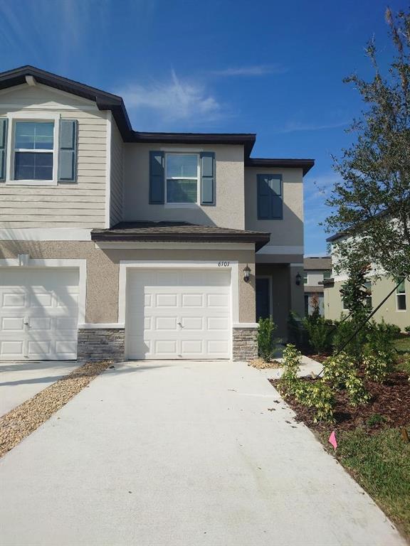 a front view of a house with a yard and garage