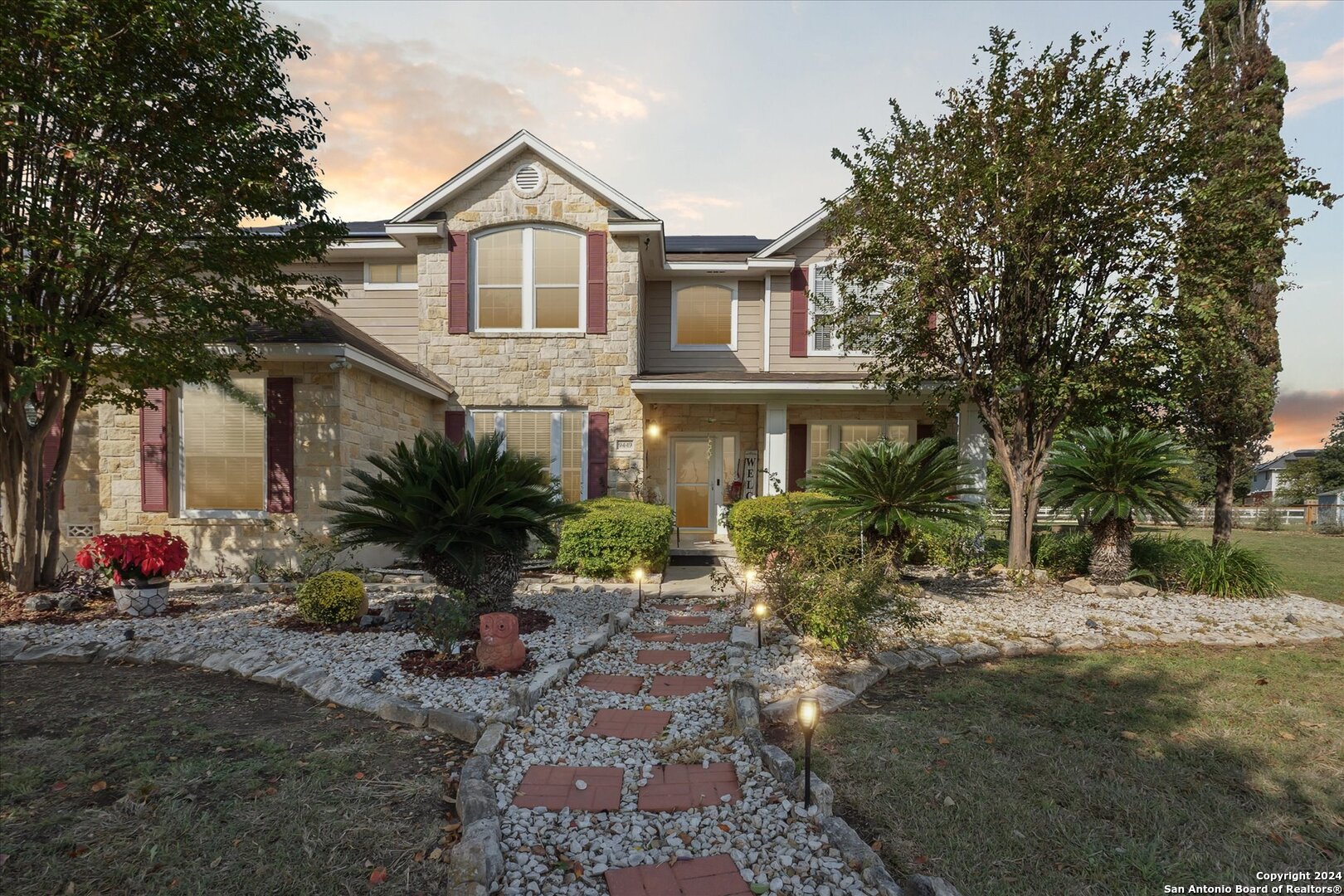 a front view of a house with garden