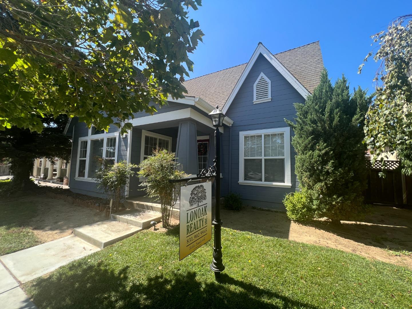 a front view of a house with yard and green space