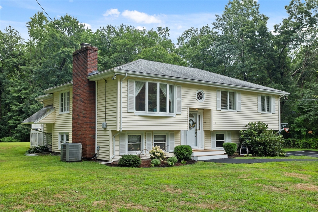 a front view of house with yard and green space