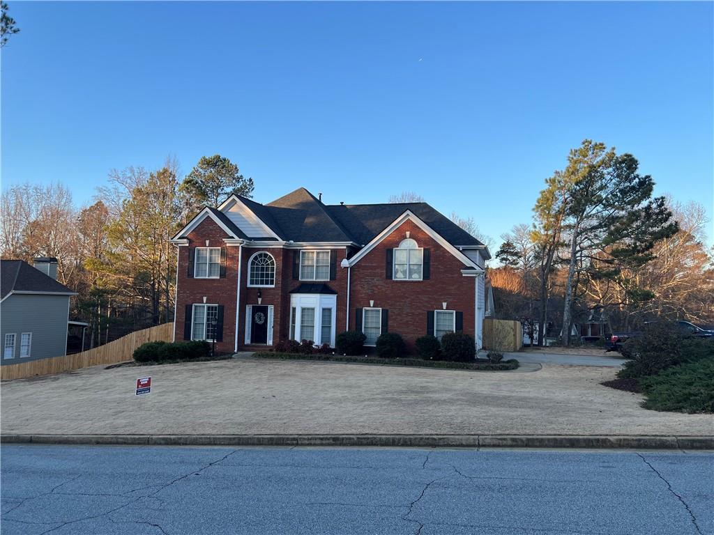 a front view of a house with a yard