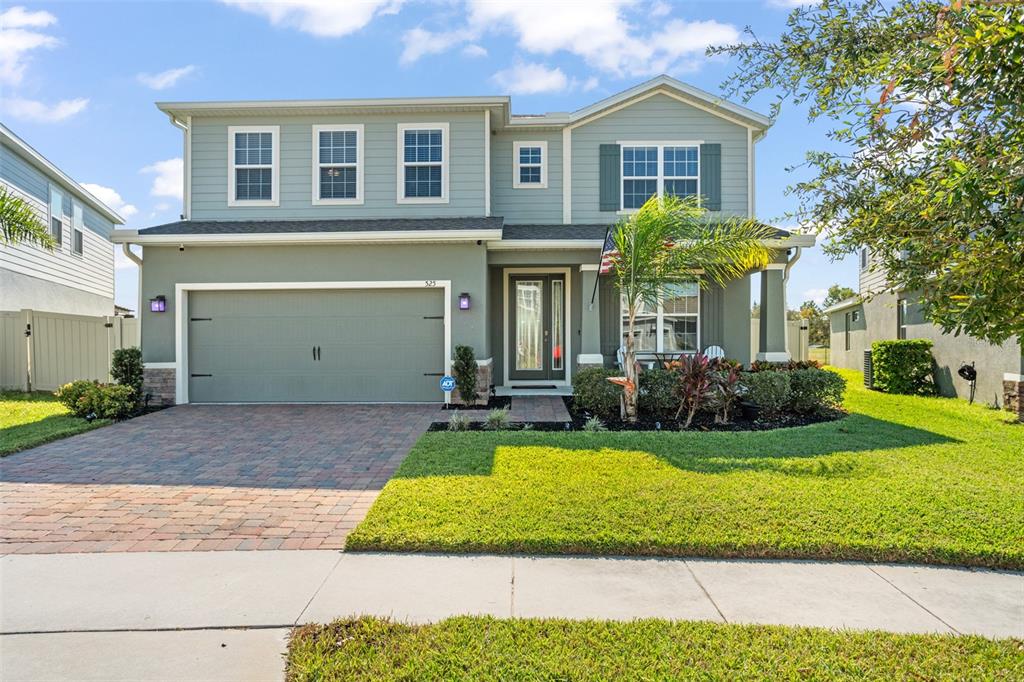 a front view of a house with a yard and garage