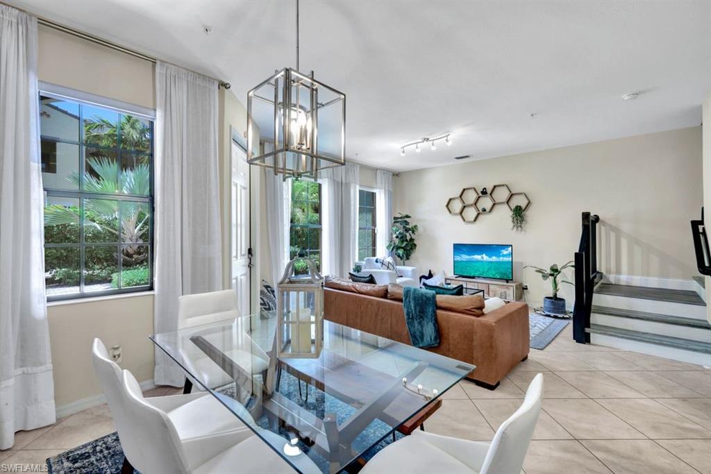 a living room with furniture a window and a chandelier