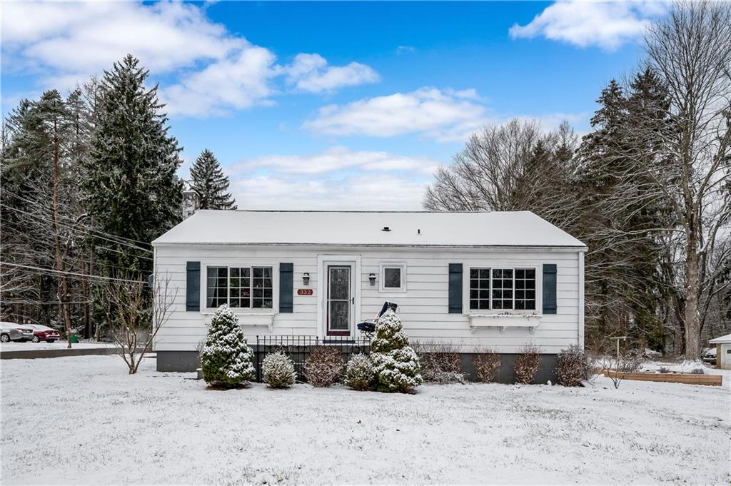 a view of a house with a yard covered in snow