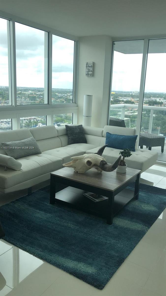 a living room with couch and a large window