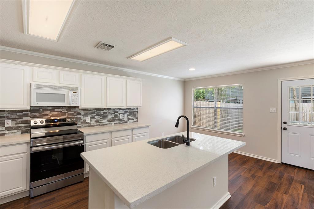 a kitchen with a stove a sink and a refrigerator