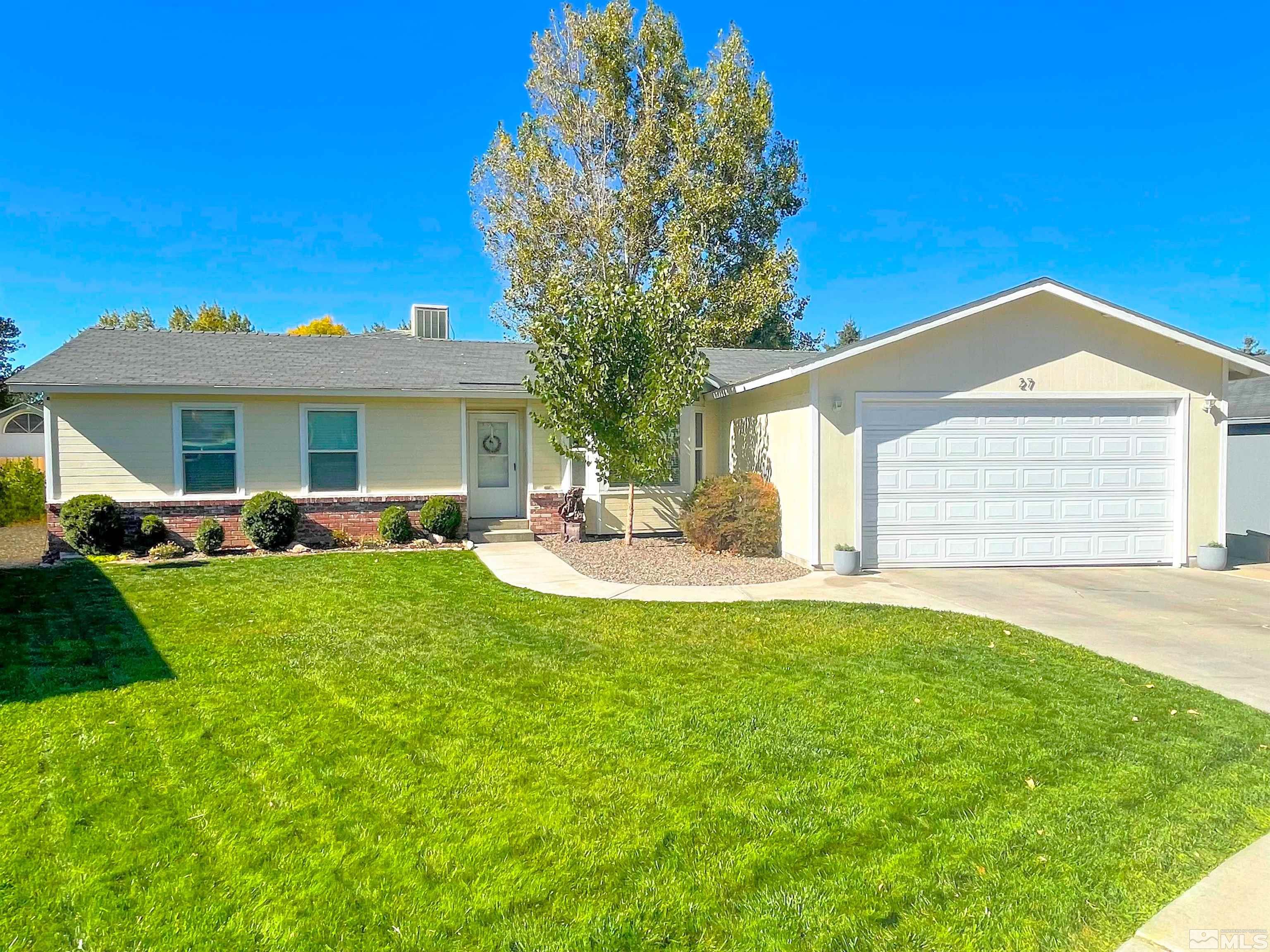 a view of a house with a backyard and a patio