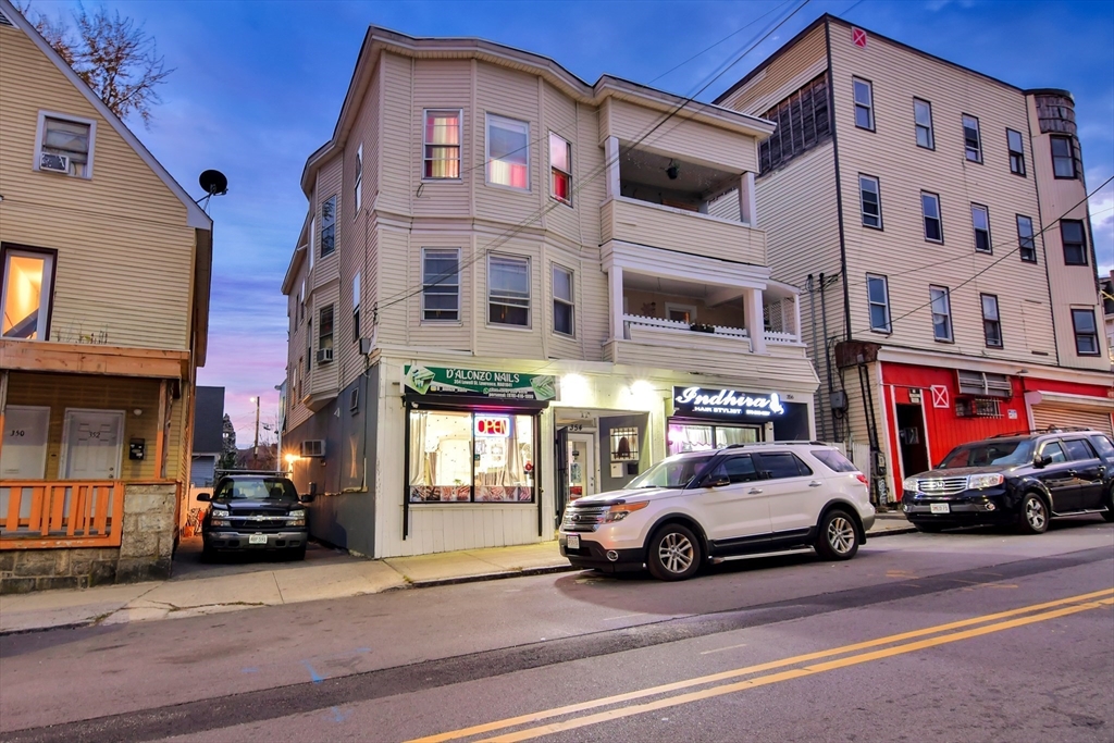 a view of a cars park in front of a building