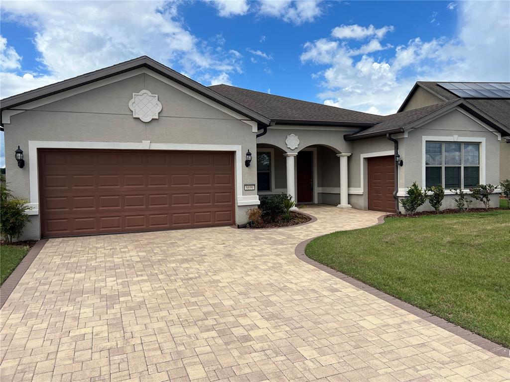 a front view of a house with a yard and garage