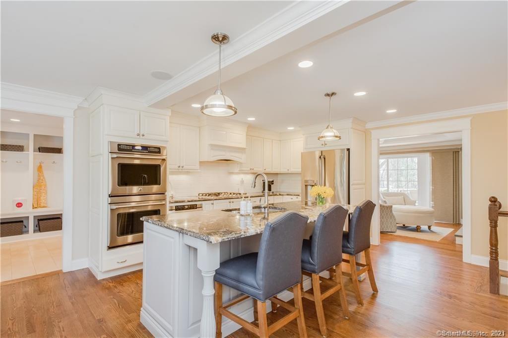 a kitchen with cabinets a counter space stainless steel appliances and wooden floor