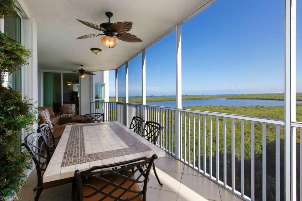 a view of a balcony dining area and kitchen view