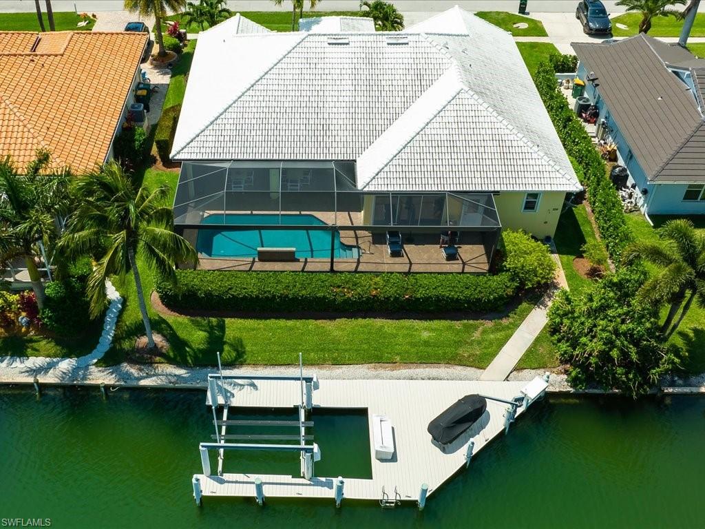 an aerial view of a house with swimming pool and outdoor seating