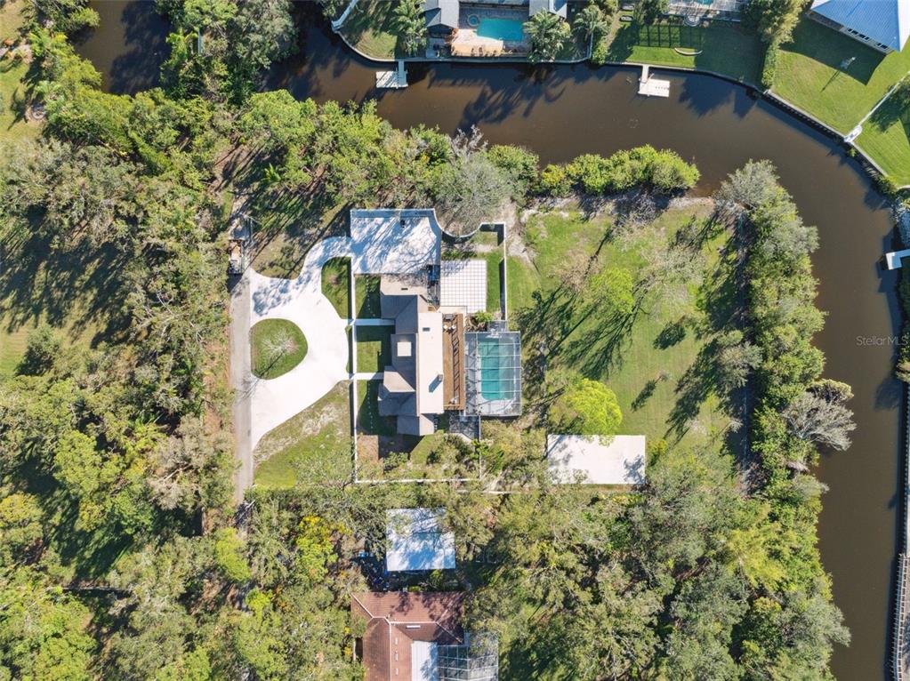 an aerial view of a house with a lake view