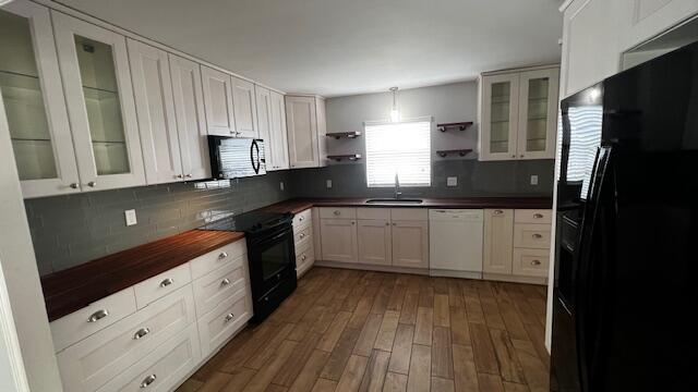 a kitchen with granite countertop a sink stainless steel appliances and cabinets