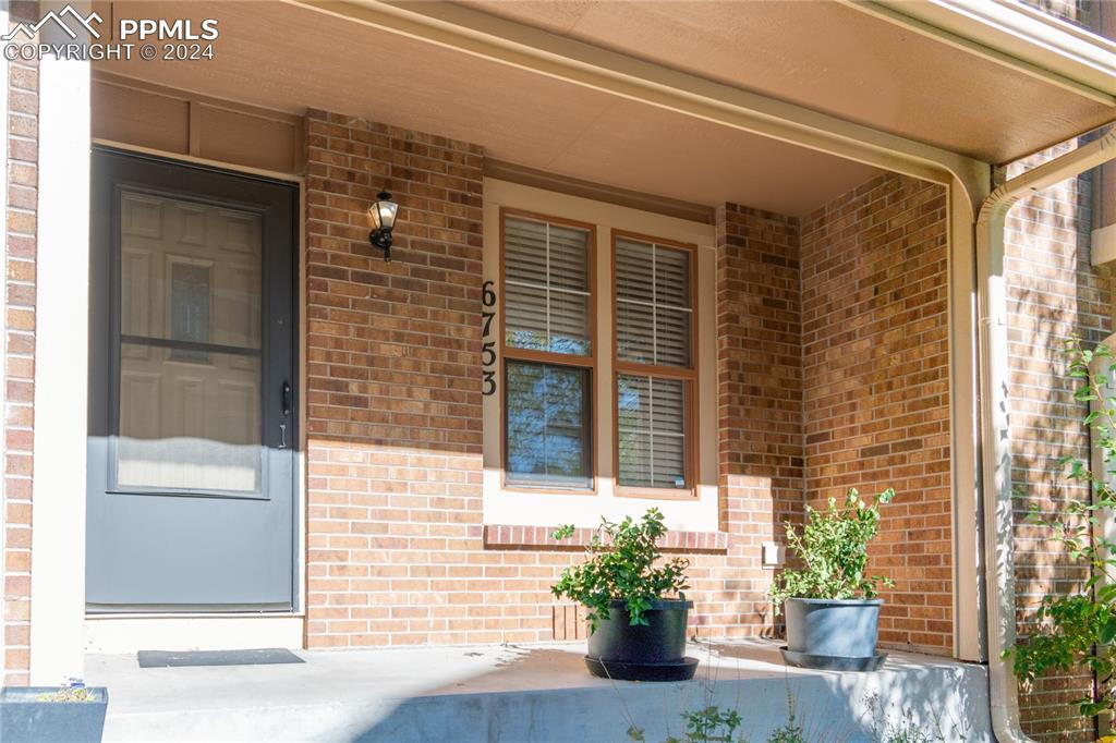 a front view of a house with a potted plant