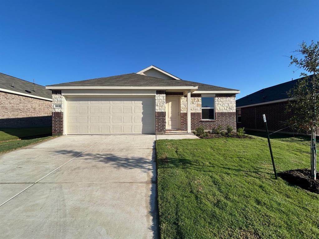 a front view of a house with a garden and yard