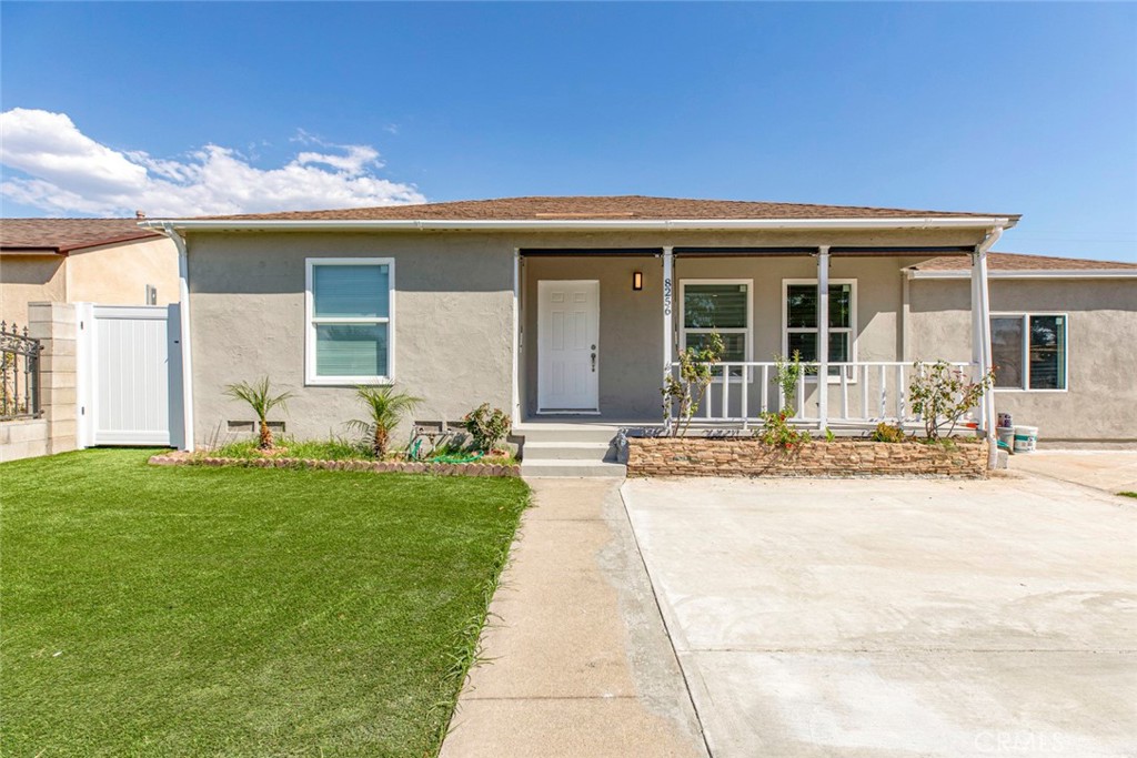 a front view of a house with yard outdoor seating and garage