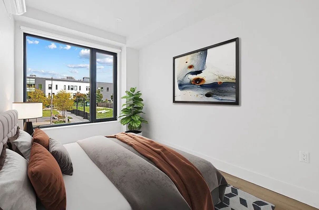 a bed sitting in a bedroom next to a window